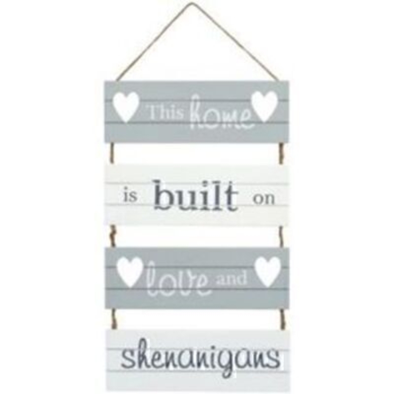 ''This home is built on love and shenanigans' Slatted Plaque by Transomnia. Grey and white shabby chic style wall plaque made from slatted wood and tied together with twine. A lovely happy sign for any age. Size: 30 x 18 x 0.8cm